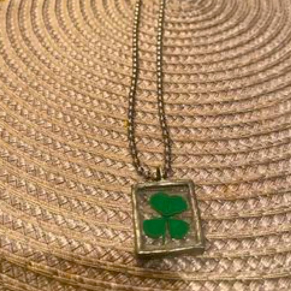 Four leaf clover in glass - pendant on 20” silver necklace.